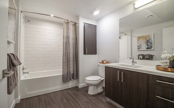 Modern bathroom with glass shower and sleek fixtures in MODA at Monrovia Station Apartments