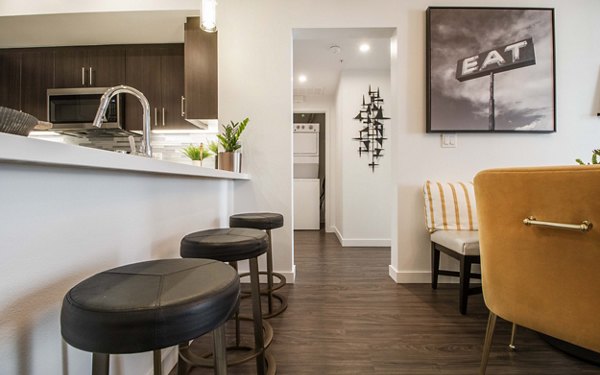 Modern kitchen with stainless steel appliances at MODA at Monrovia Station Apartments