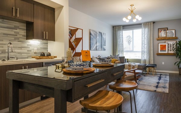 Modern kitchen with stainless steel appliances at MODA at Monrovia Station Apartments