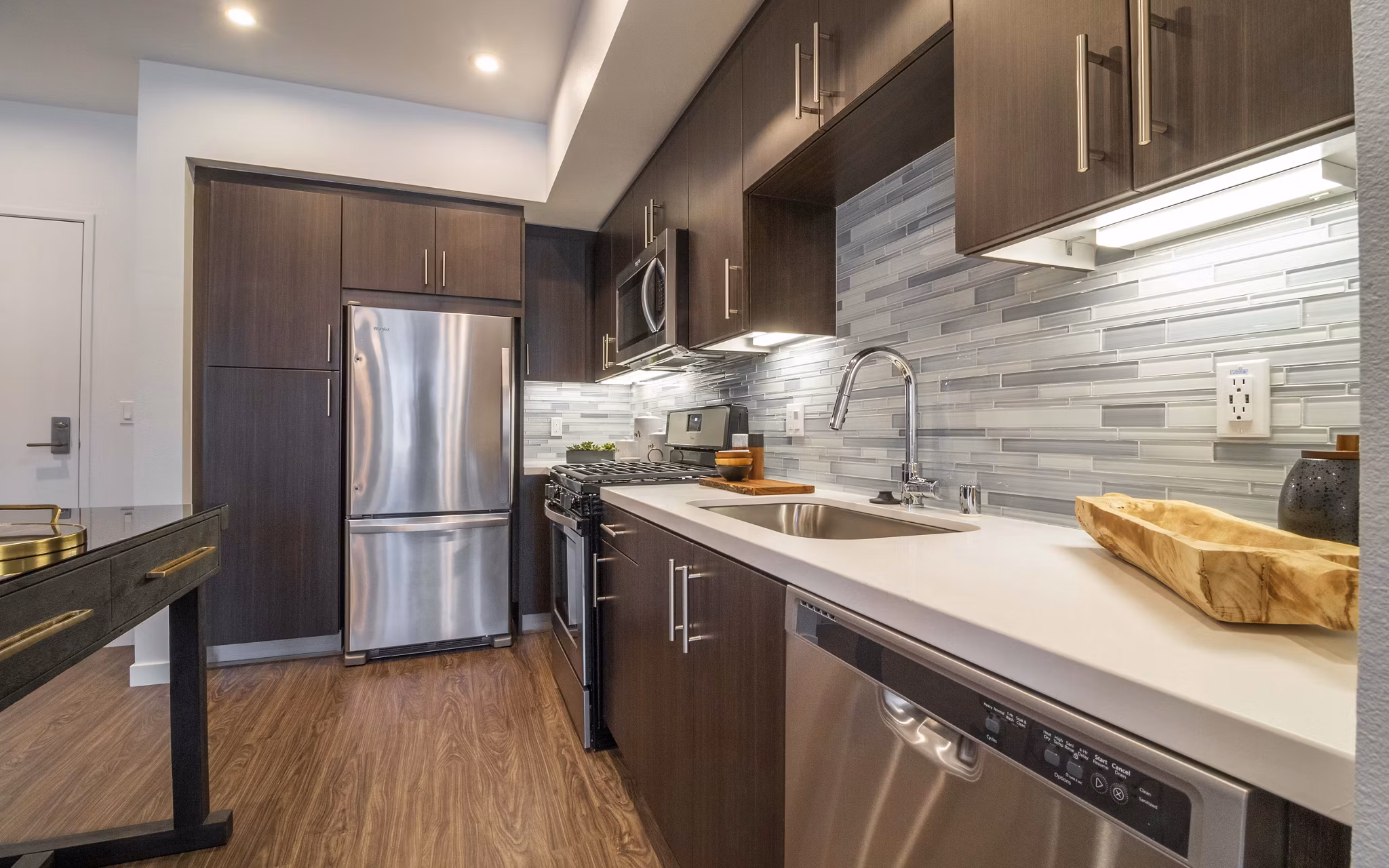 Contemporary kitchen with stainless steel appliances at MODA at Monrovia Station Apartments