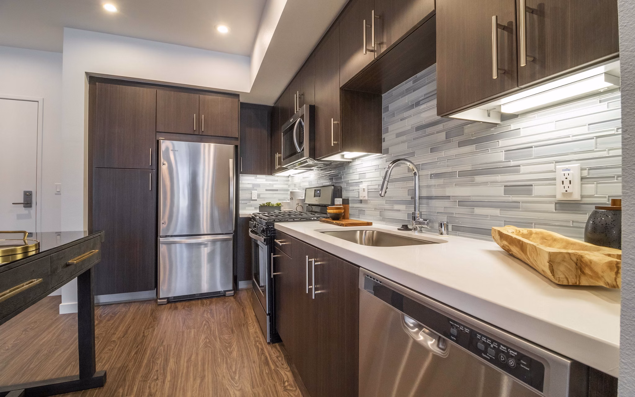 Contemporary kitchen with stainless steel appliances at MODA at Monrovia Station Apartments