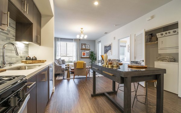 Modern kitchen with sleek countertops and stainless steel appliances at MODA at Monrovia Station Apartments