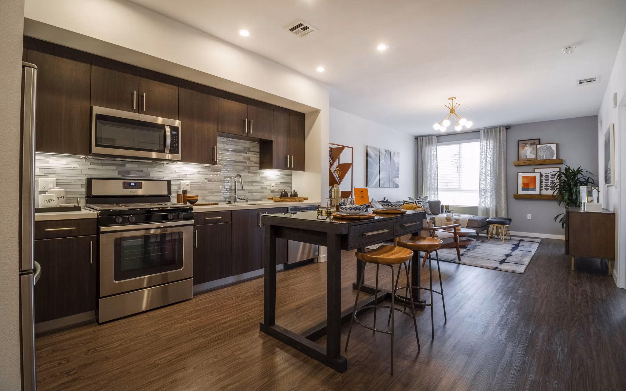 Modern kitchen with sleek countertops and stainless steel appliances at MODA at Monrovia Station Apartments