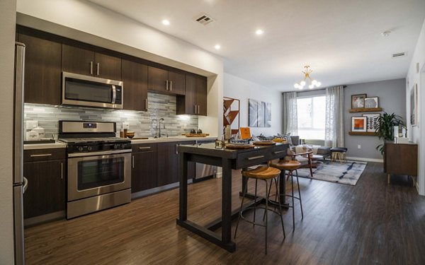 Modern kitchen with sleek countertops and stainless steel appliances at MODA at Monrovia Station Apartments