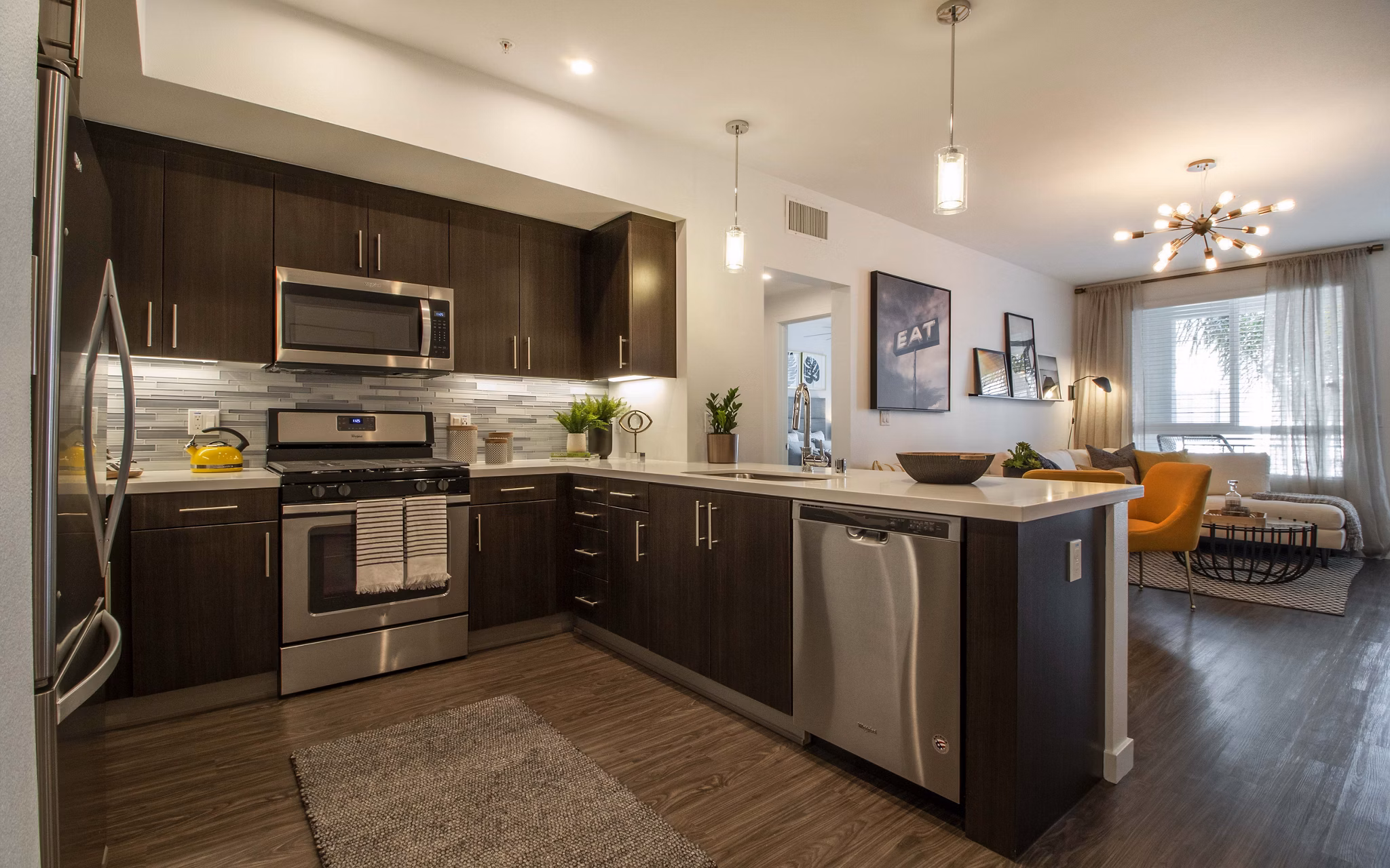 Modern kitchen with stainless steel appliances at MODA at Monrovia Station Apartments