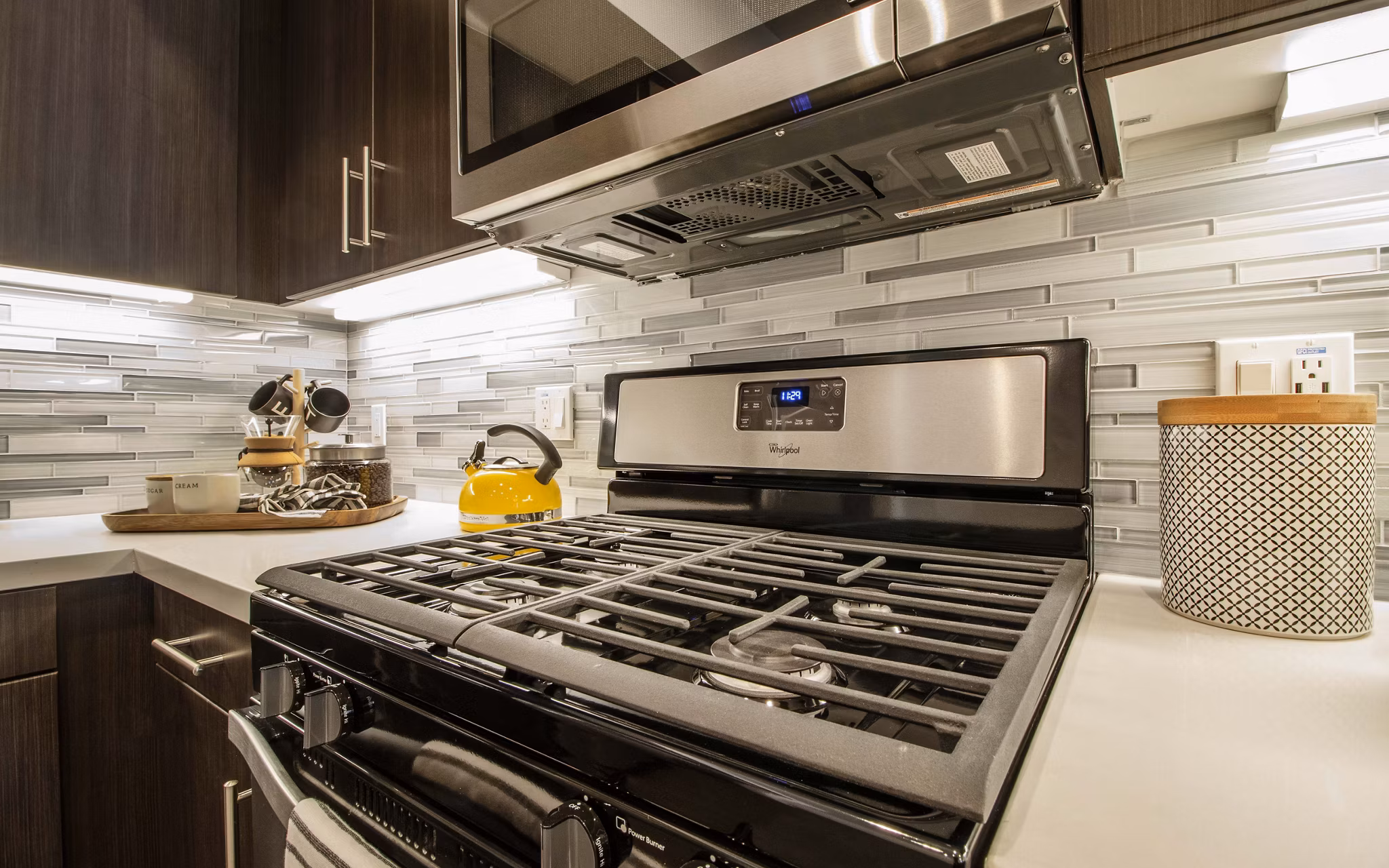 Modern kitchen with stainless steel appliances at MODA at Monrovia Station Apartments