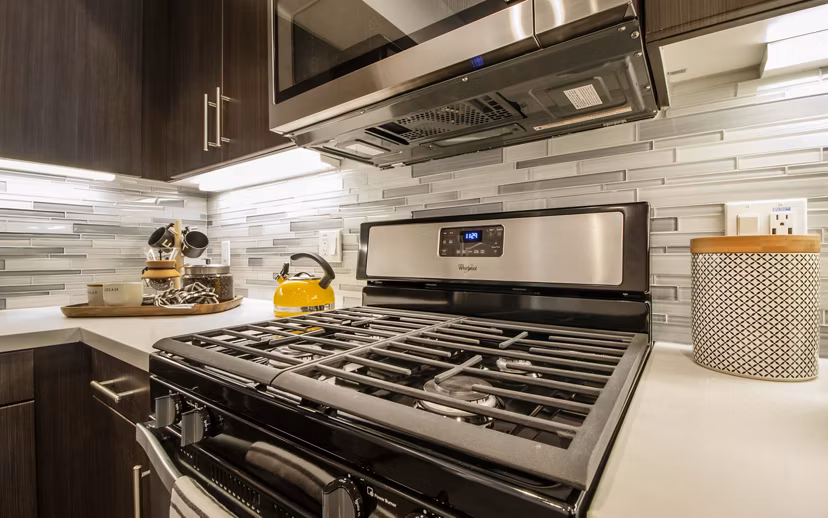Modern kitchen with stainless steel appliances at MODA at Monrovia Station Apartments