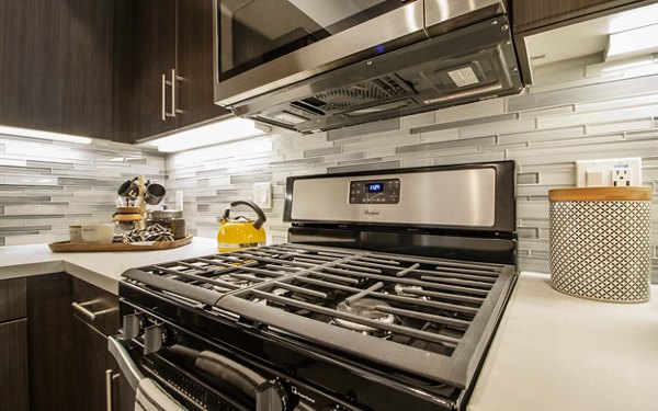 Modern kitchen with stainless steel appliances at MODA at Monrovia Station Apartments