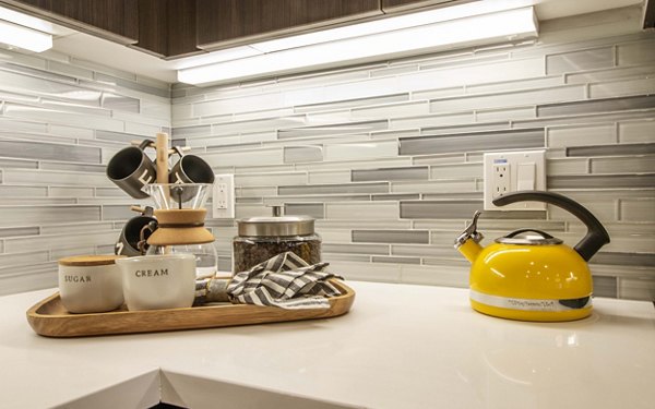 Modern kitchen with stainless steel appliances at MODA at Monrovia Station Apartments