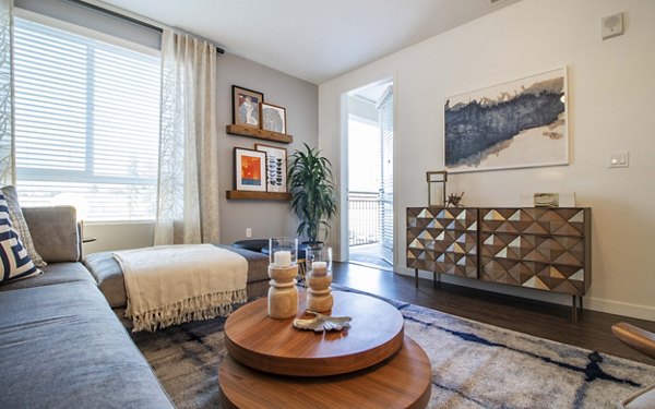 Modern living room with elegant furniture and large windows at MODA at Monrovia Station Apartments