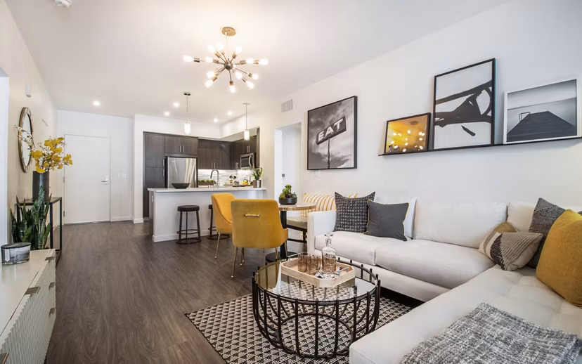 Spacious living room with modern decor and natural light at MODA at Monrovia Station Apartments