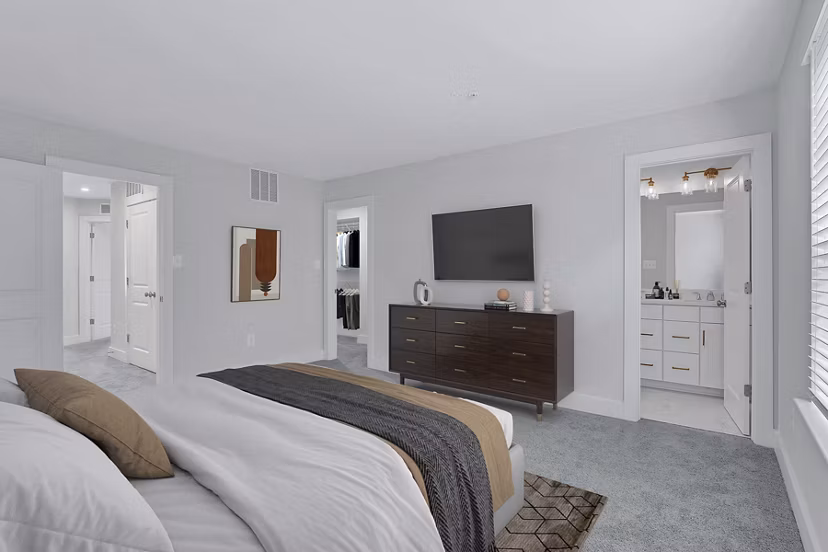 Cozy bedroom with modern decor and soft lighting at Brookestone Townhomes