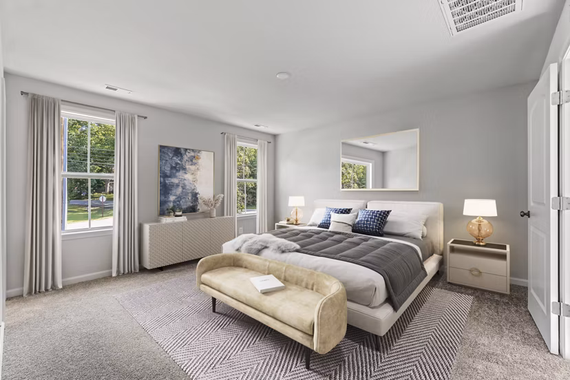 Luxurious bedroom with elegant decor at Brookestone Townhomes, featuring stylish furnishings and ample natural light
