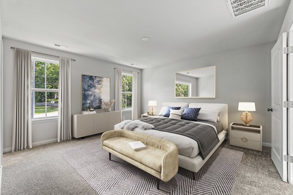 Luxurious bedroom with elegant decor at Brookestone Townhomes, featuring stylish furnishings and ample natural light