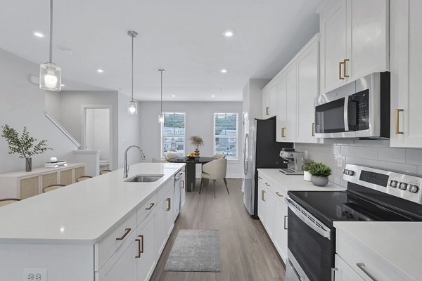 Kitchens featuring modern appliances and granite countertops at Brookestone Townhomes, luxury living by Greystar