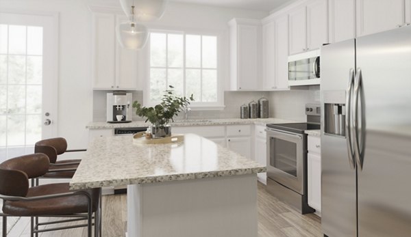 Modern kitchen with stainless steel appliances in Brookestone Townhomes