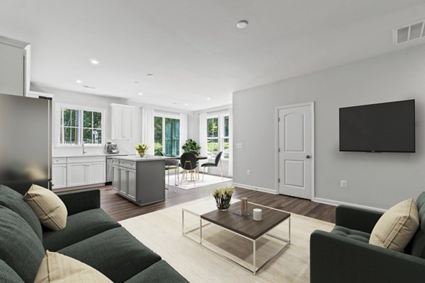 Cozy living room with contemporary decor and natural light in Brookestone Townhomes