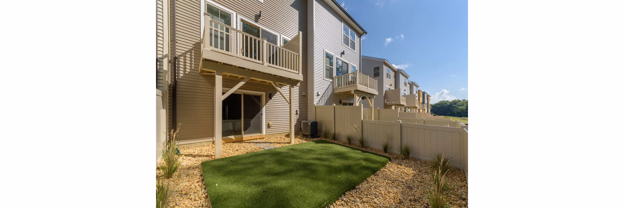 Charming patio with dining set and garden view at Brookestone Townhomes: luxury living in a serene environment
