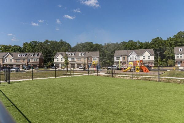 Spacious dog park with agility equipment at Brookestone Townhomes, perfect for residents and their furry friends
