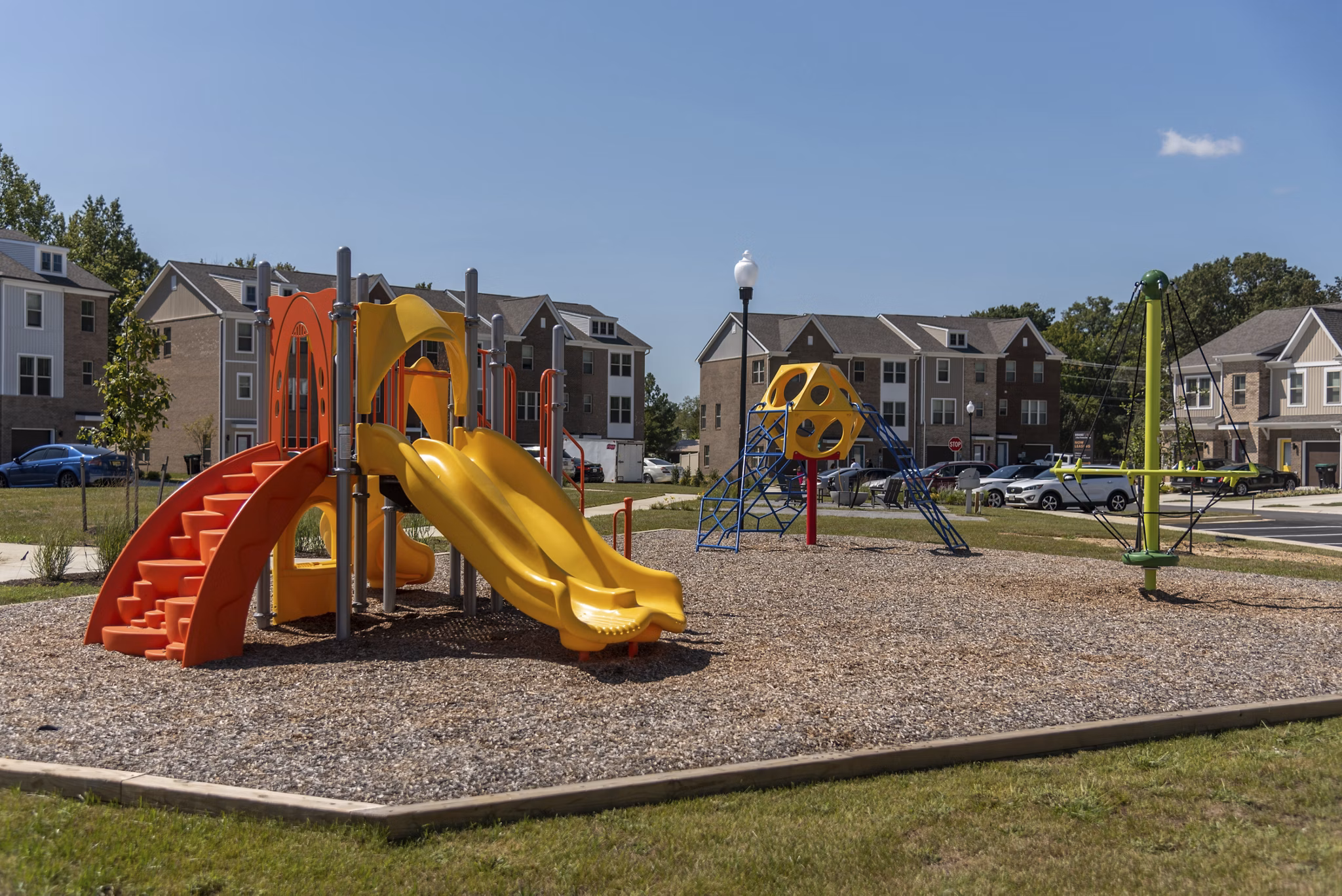 Family-friendly playground at Brookestone Townhomes with modern equipment and safe play area