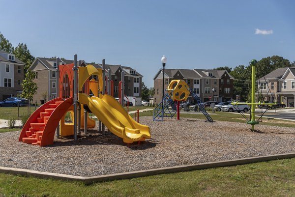 Family-friendly playground at Brookestone Townhomes with modern equipment and safe play area