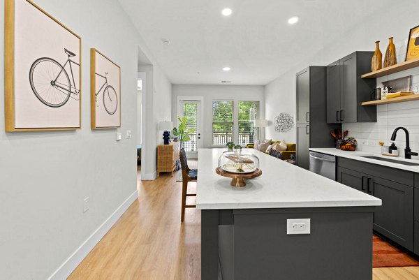 Modern kitchen with sleek countertops and stainless steel appliances in NOVEL Morrisville Apartments