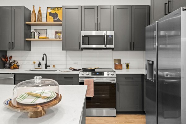 Modern kitchen with stainless steel appliances at NOVEL Morrisville Apartments