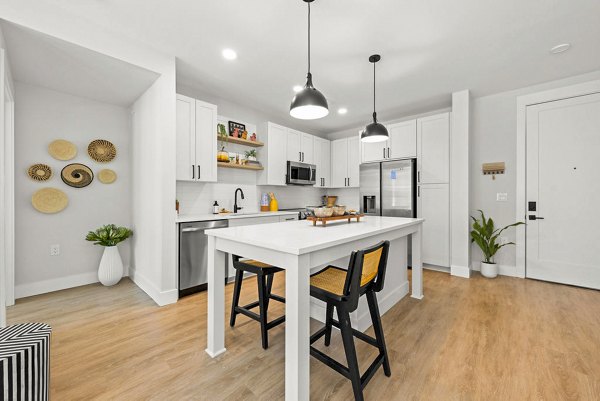 Modern kitchen with stainless steel appliances at NOVEL Morrisville Apartments