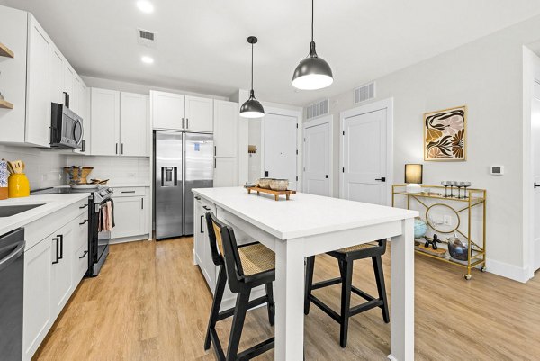 Modern kitchen with sleek countertops and stainless steel appliances at NOVEL Morrisville Apartments