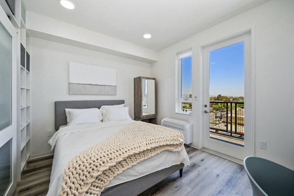Cozy bedroom with modern decor at 2911 Adams Apartments, luxury living in a central location