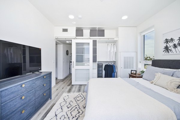 Bedroom featuring cozy decor and large windows at 2911 Adams Apartments, luxury living in an urban setting