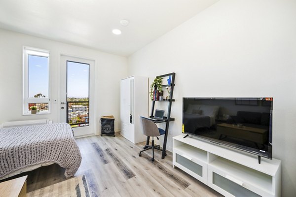 Inviting bedroom with cozy decor and large windows at 2911 Adams Apartments