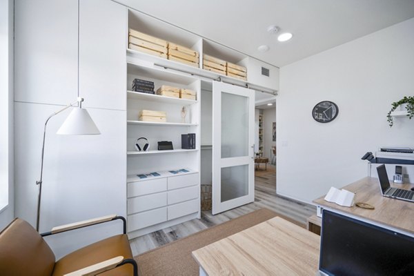 Home office with modern desk and ergonomic chair at 2911 Adams Apartments