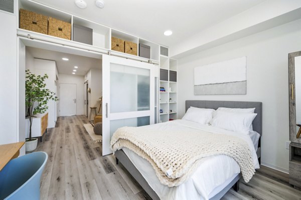 Cozy bedroom with modern decor at 2911 Adams Apartments offering luxury living in urban style