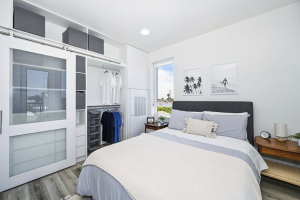 Cozy bedroom featuring stylish decor and ample natural light at 2911 Adams Apartments