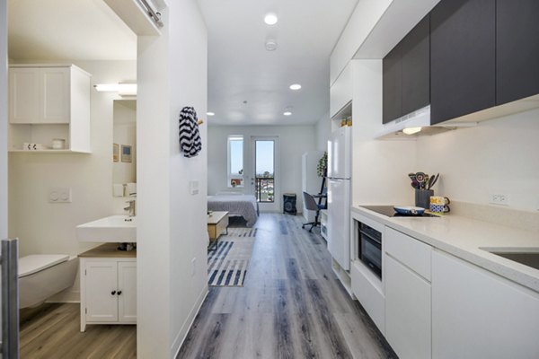 Modern kitchen with stainless steel appliances at 2911 Adams Apartments, offering luxury living spaces in the heart of the city