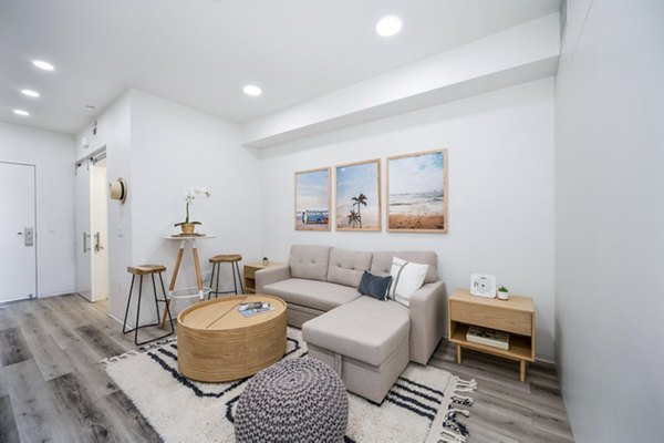 Elegant living room with modern decor and ample natural light at 2911 Adams Apartments