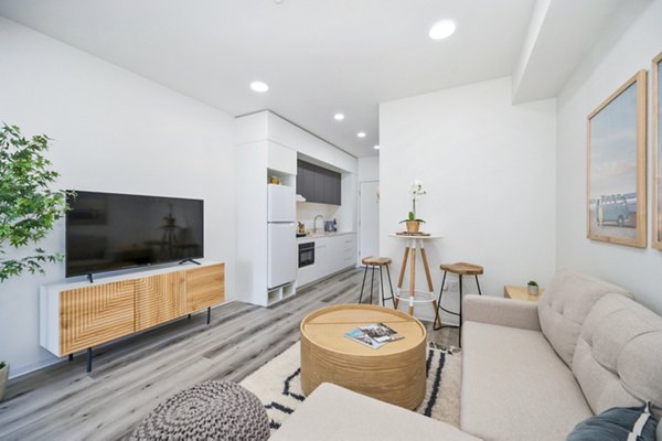 Spacious living room with modern decor in 2911 Adams Apartments, offering luxury living in an urban setting