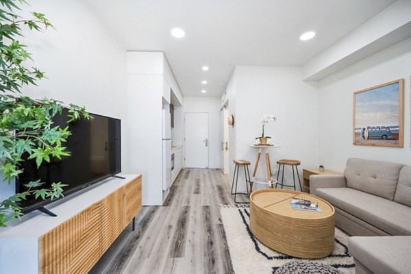 Spacious living room with modern decor at 2911 Adams Apartments, featuring a cozy seating area and natural lighting