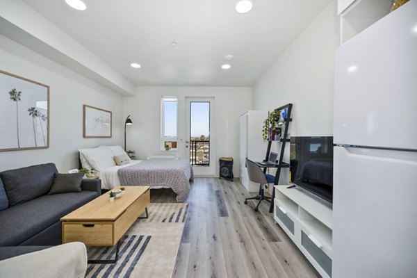 Elegant living room with modern decor in 2911 Adams Apartments, featuring cozy seating and ample natural light perfect for relaxation