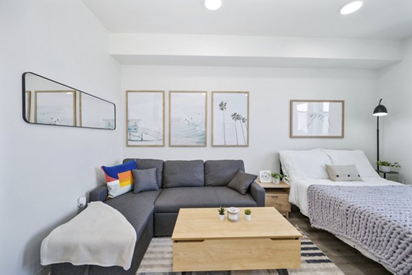 Spacious living room with modern decor and large windows at 2911 Adams Apartments