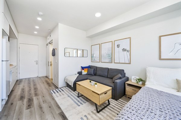 Spacious living room with modern decor and natural lighting in 2911 Adams Apartments