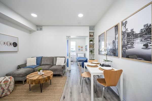 Spacious living room with modern furnishings and natural light at 2911 Adams Apartments, a Greystar luxury apartment property