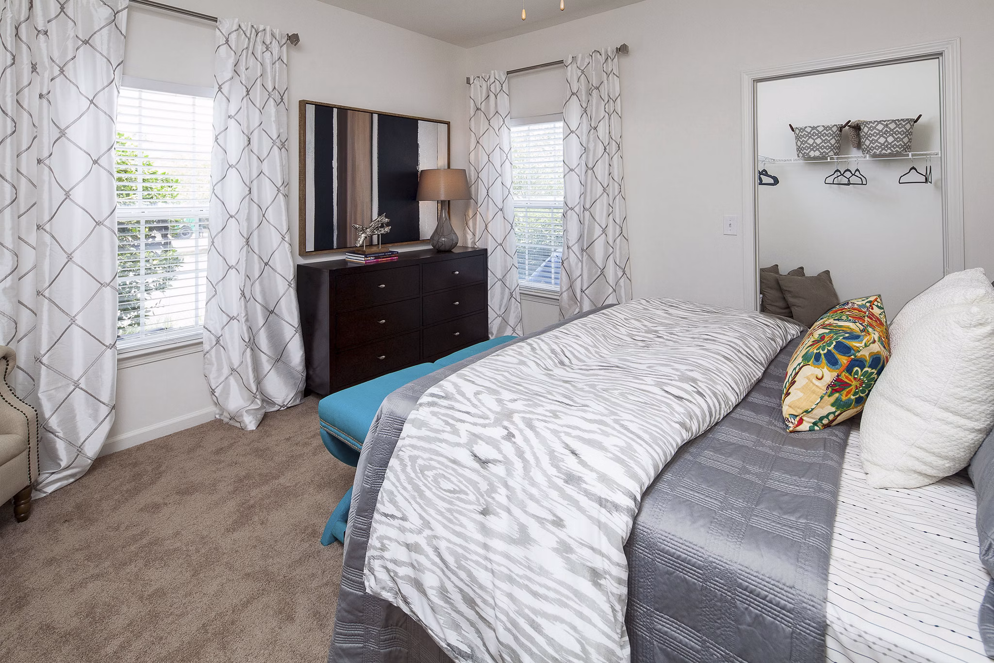 Bedroom featuring modern furnishings and natural light at Avana Portico Apartments