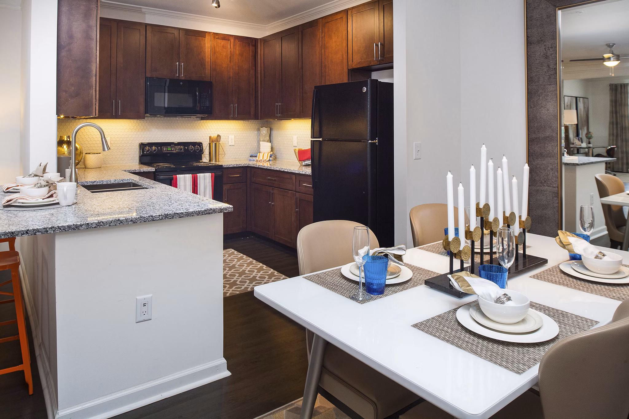 Dining area with elegant seating and modern lighting in Avana Portico Apartments