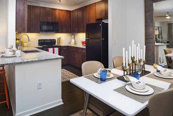 Dining area with elegant seating and modern lighting in Avana Portico Apartments