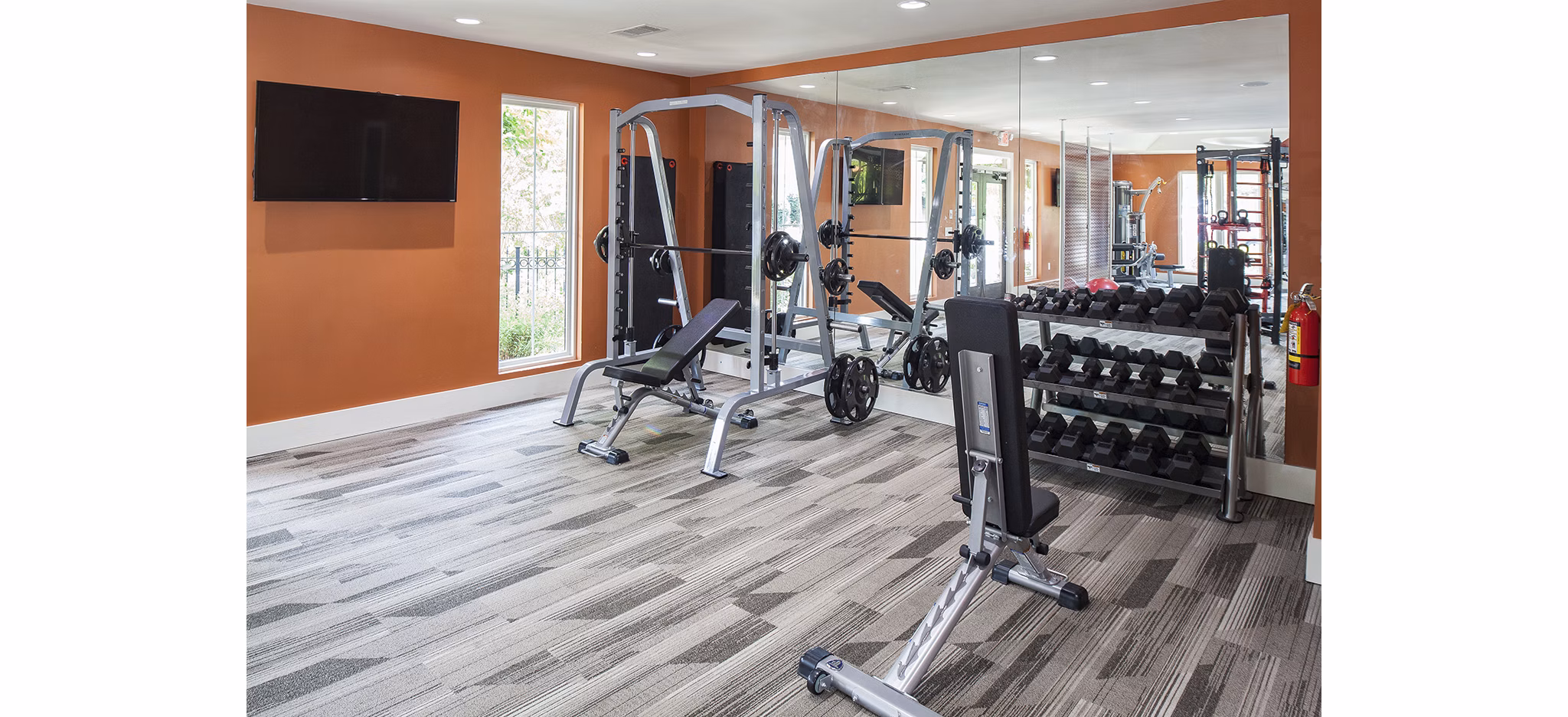 Modern fitness center with state-of-the-art equipment at Avana Portico Apartments, ideal for luxury healthy living