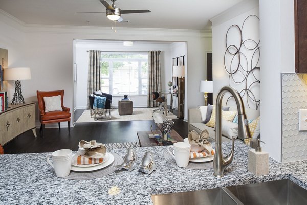 Modern kitchen with granite countertops and stainless steel appliances at Avana Portico Apartments