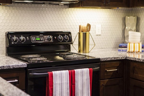 Sleek kitchen with stainless steel appliances in Avana Portico Apartments