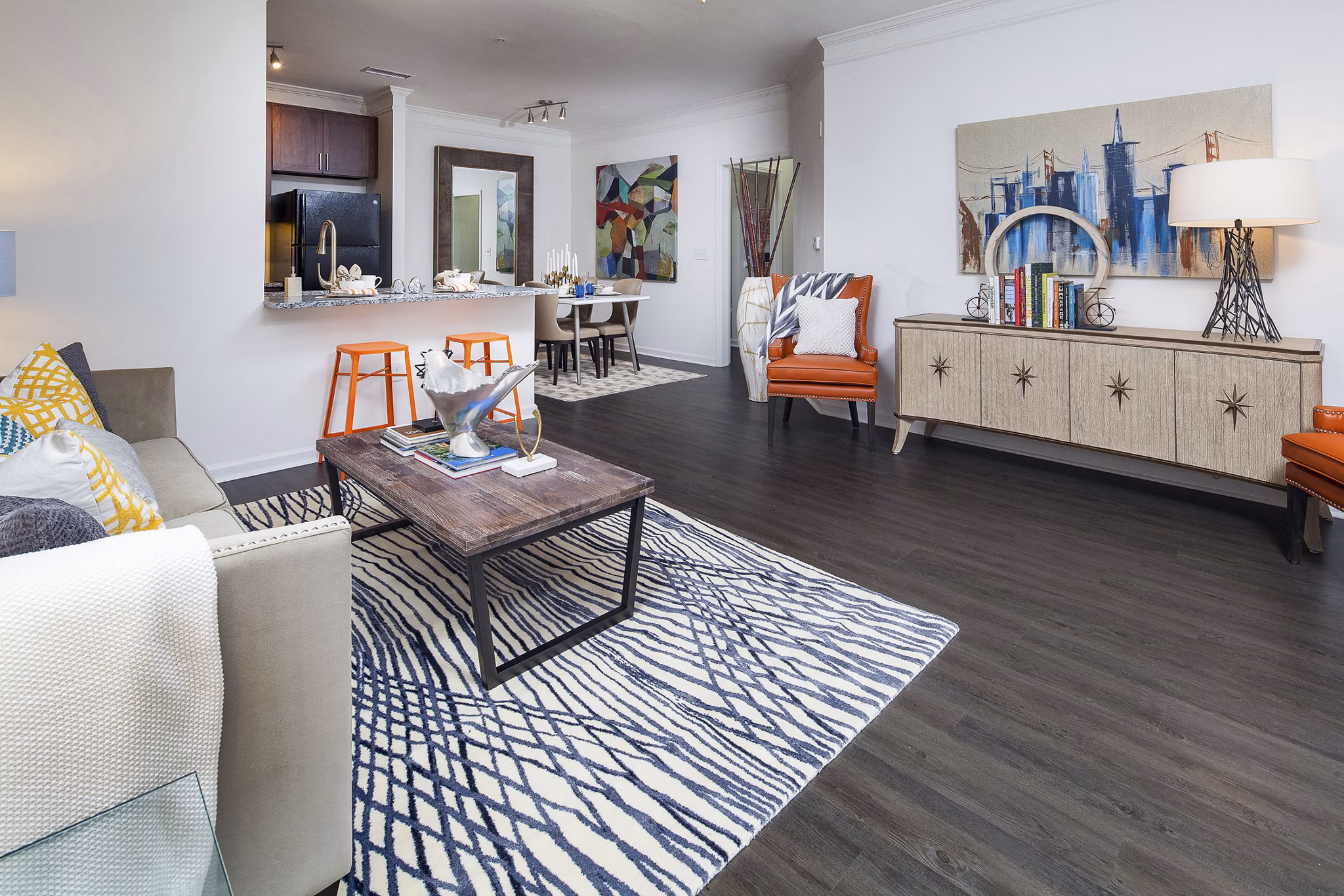 Spacious living room with modern decor and large windows at Avana Portico Apartments, providing a comfortable and elegant living space